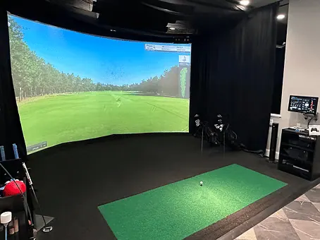 Indoor golf simulator with turf